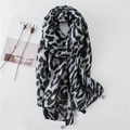Grey leopard print cotton linen shawl with fringe tassels laid on a minimalist background - Grey Leopard