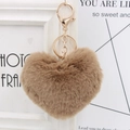 Detailed macro view of heart-shaped faux fur keychain in khaki with gold metal hardware - Khaki