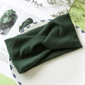 Dark green knitted twist headband with ribbed texture in a stylish cross design - Green
