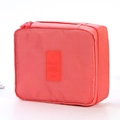 Waterproof travel toiletry bag in coral pink with double zippers and airplane icon logo - Watermelon red