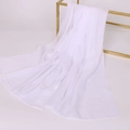 Elegant white semi-transparent chiffon scarf hanging on a gold metal display rack - White