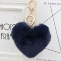 Close-up of heart-shaped faux fur keychain in deep blue with gold metal hardware and ring - Navy Blue
