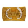 Close-up of ginger yellow nylon headband with white lace trim and bow for babies - Ginger Yellow