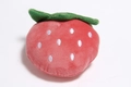 Detailed close-up of a strawberry-shaped plush dog toy with soft red fabric and green leaves - Pink Strawberry