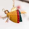 Macro view of hand-painted iron angel ornament with vintage finish and hanging string - C3 Angel