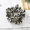 Detail of soft leopard print satin scrunchie on marble background with smooth texture - Small Leopard Black White