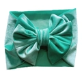 Detail of teal velvet baby headband featuring a soft texture and a large decorative bow - Mint Green