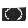 Detail view of a black nylon baby headband with white lace trim and a large soft bow knot - Black