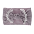 Detail of dusty purple baby headband featuring a large bow with white lace trim edges - Purple Grey