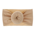 Detail view of ultra-soft light brown nylon baby headband with a donut knot design - Nude