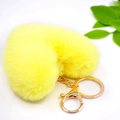 Detail view of a fluffy yellow heart-shaped plush keychain with gold-tone hardware - Gold Keychain / Yellow
