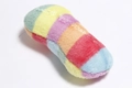 Detailed close-up of rainbow striped plush pet toy with soft multicolored long fur texture - Rainbow Bone
