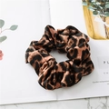 Detail shot of leopard print scrunchie on marble background showing silky satin texture - Leopard Coffee
