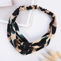 Detail view of elastic twist headband with beige and green leopard print on white background - Grass Green