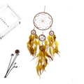 Close-up of brown dreamcatcher with handmade woven webs, colorful beads and feathers - Yellow