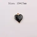 Detail of a 15x17mm black glitter heart pendant with gold-tone alloy edge for DIY jewelry - Black Series