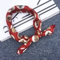 Elegant red silk square scarf featuring cartoon owl print tied in a decorative knot - Owl