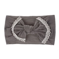 Close-up detail of a grey super soft nylon baby headband with a lace-trimmed bow - Gray