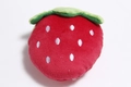 Top down macro view of strawberry plush dog toy showing red fabric and green leaf detail - Red Strawberry