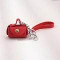 Mini red PU leather keychain pouch with gold snap button and red silicone wrist strap - Red