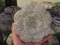 Macro shot of silver crystal flower evening bag with sparkling rhinestones and gold stamen - Gold White