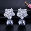 Detail of snowflake zircon earrings with a dark grey pearl drop on a textured background - Grey Style (E0106-2)