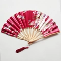 Detail of red Japanese folding fan with floral patterns and wooden ribs on white background - NO14 Wine Red