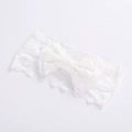 Detailed close-up of a white lace baby headband featuring a delicate bow design - 4 White