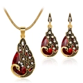 Detailed view of peacock jewelry set with red teardrop crystals and white rhinestones - Red