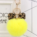 Close-up of yellow faux fur pompom keychain with leopard print bow and crystal details - Yellow Leopard