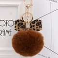 Close-up of brown faux fur pompom keychain with leopard bow and rhinestone details - Brown Leopard