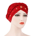 Detail of red turban cap with braided headband and golden floral beadwork decoration - Burgundy