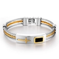 Macro detail of men's two-tone braided stainless steel bracelet with cross and black enamel - 22cm / Gold & Silver