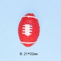 Detailed view of red resin rugby ball flatback with white stitching and size dimensions - B-Rugby Ball