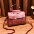 Retro burgundy leather handbag with metal bar detail and adjustable shoulder strap - Dusty Pink