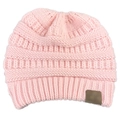 Close-up of pink cable knit ponytail hat featuring a ribbed brim and brown leather patch - Pink