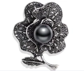 Macro detail of retro gun-black rose brooch with dark pearls and sparkling rhinestones - Rose Shape - Black Pearl Marcasite