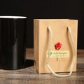 Brown kraft paper gift bag with red rose and Just for you label on dark wood desk - Kraft Paper Gift Bag with Red Rose