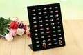 L-shaped jewelry display stand with 50 slots on wooden surface with decorative roses - Black Velvet