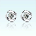 Macro shot of silver rotating flower stud earrings with a sparkling central zircon stone - Whirl Flower Silver (JED039)