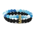 Detail of blue marble beads and black lava rock beads with gold crown metal accents - Lava Stone Set Gold
