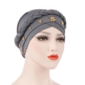 Detail of dark grey turban featuring braided wrap and gold floral bead embellishments - Gray