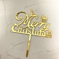 Golden acrylic Merry Christmas cake topper with mirror finish on grey background - Gold