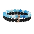 Macro shot of blue gradient beads and black lava stone bracelets with rose gold crowns - Lava Stone Set Rose Gold