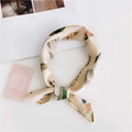 Silk-feel beige square scarf with colorful feather print tied in an elegant bow - 16 Feather Beige