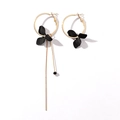 Detailed view of asymmetric gold and black petal drop earrings with stylish long tassels - Black