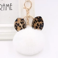 Close-up of white plush pompom keychain with leopard print ears and gold metal clip - Gold Key Chain Style / White