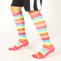 Rainbow striped over-the-knee compression sports socks shown on a model - SM / Deep Pink