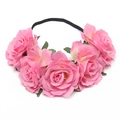 Detail of five pink faux roses and green leaves on an elastic bridal flower headband - Deep Pink