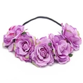 Detail of purple fabric roses and green leaves on a black elastic bridal headband - Violet